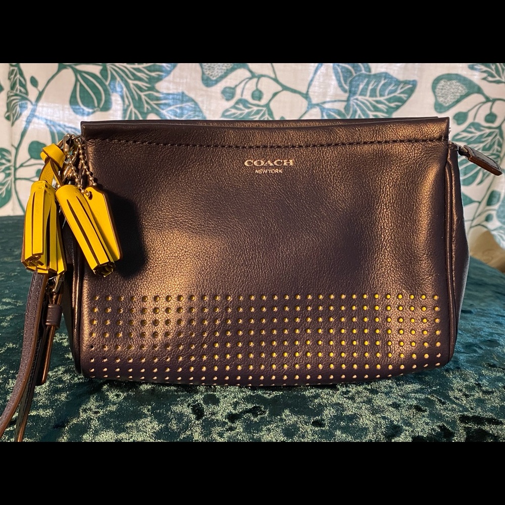 Navy Coach wristlet clutch with yellow tassels